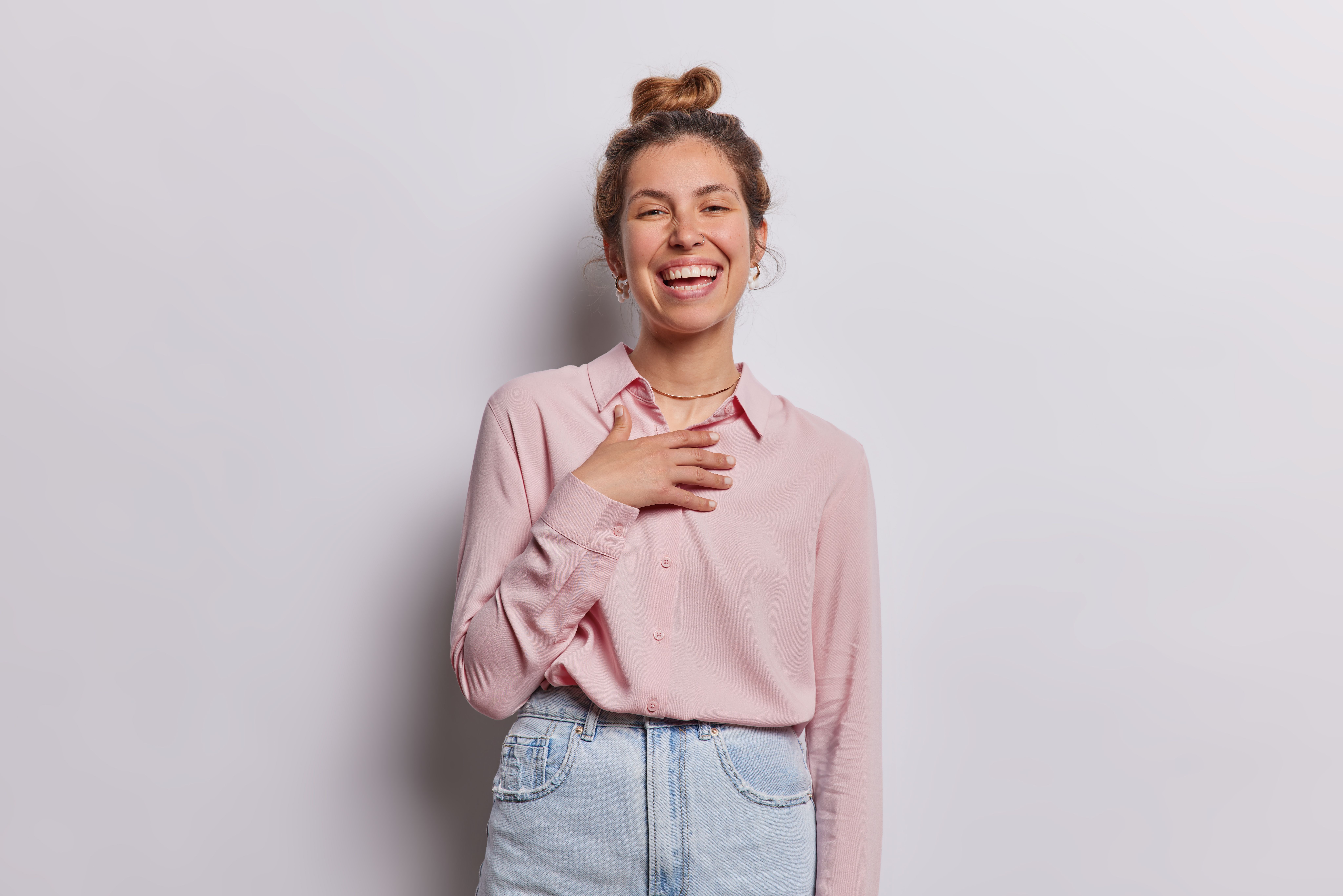 A woman smiling, hand to her heart